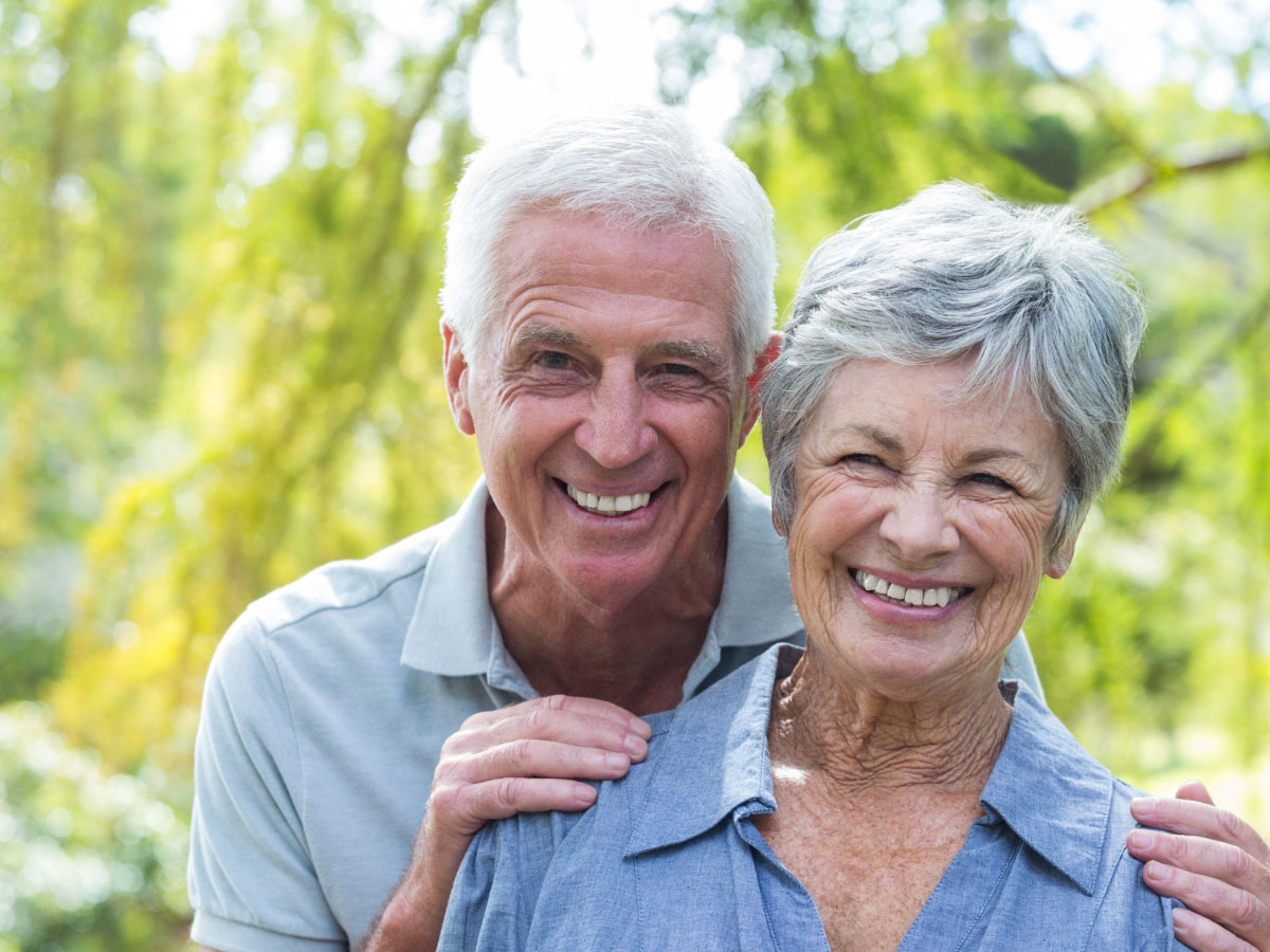 Senior patient smiling with dentist in Burnaby for seniors